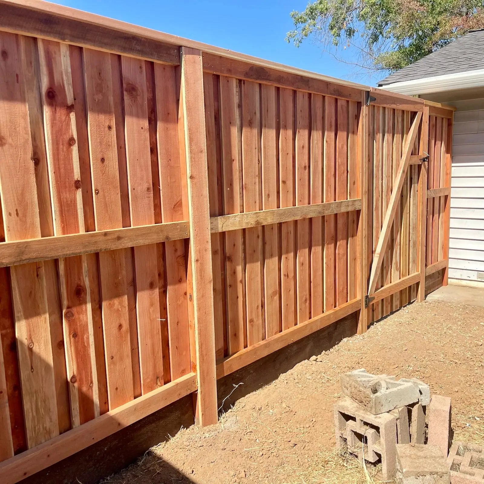 White vinyl privacy fence along driveway